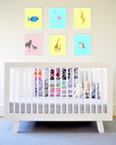 Blue Flamingo Mom and Baby Art Print in White Frame Hanging Over Baby Crib
